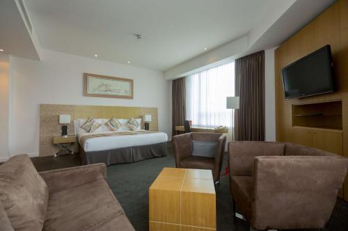a hotel room with a bed and a television at Park Plaza Cardiff in Cardiff
