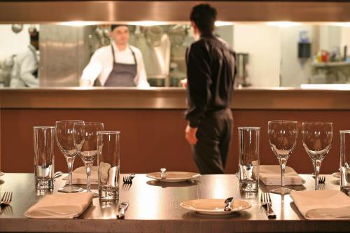 a table in a restaurant with wine glasses on it at Park Plaza Cardiff in Cardiff