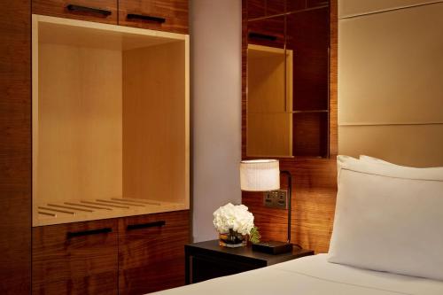 a bedroom with a bed and a large mirror at Park Plaza County Hall London in London