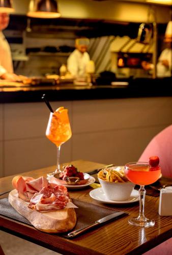 a table with plates of food and drinks on it at Park Plaza County Hall London in London
