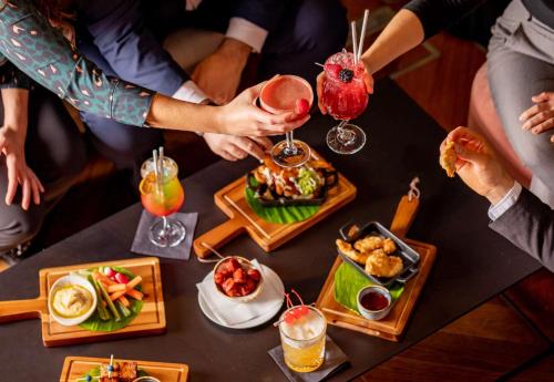 a group of people sitting around a table with food at Park Plaza County Hall London in London