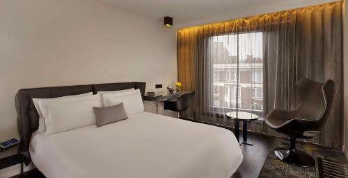 a bedroom with a white bed and a window at Park Plaza London Waterloo in London