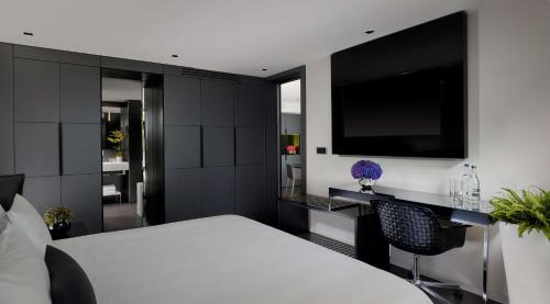 a bedroom with a white bed and a flat screen tv at Park Plaza London Waterloo in London