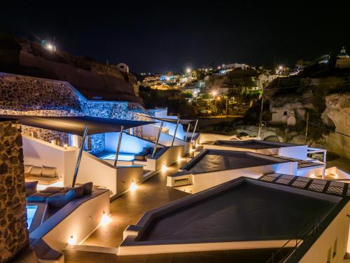 a villa with a swimming pool at night at Victoria Caves in Vóthon