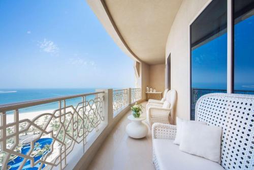 a balcony with a view of the ocean at Waldorf Astoria Ras Al Khaimah in Ras al Khaimah