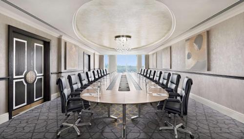 a conference room with a long table and chairs at Waldorf Astoria Ras Al Khaimah in Ras al Khaimah