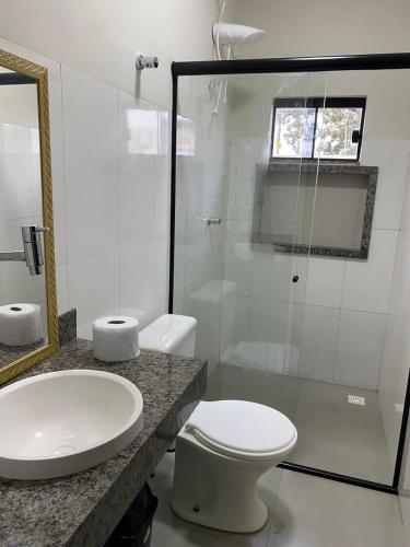 a bathroom with a toilet and a sink and a shower at Flat 03 - Prox da JK - Delior 2 in Palmas