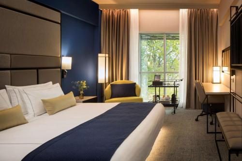 a hotel room with a large bed and a desk at Park Plaza Utrecht in Utrecht