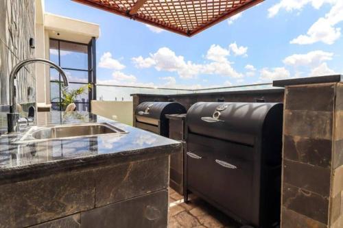 a kitchen with a sink and a counter top at Cinnamon Residence in Nairobi