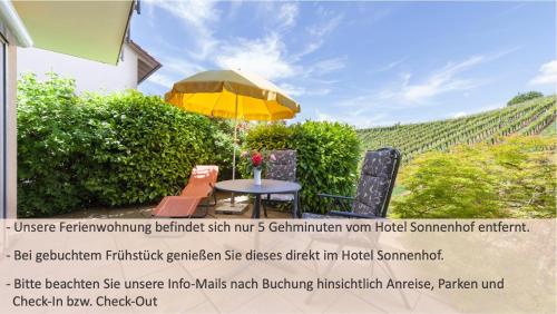 a patio with a table and an umbrella at Sonnenhof Hagnau in Hagnau