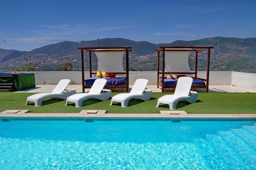 a group of chairs and a swimming pool at וילה Vision - וילה מדהימה בקצה היישוב עם בריכה ונוף עוצר נשימה in H̱azon