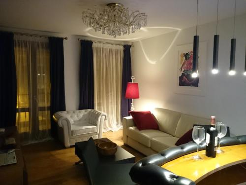 a living room with a couch and a chandelier at La Bohemia Casco Antiguo 2 in Denia