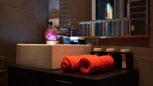 a bathroom with a red towel on a counter at La Bohemia Casco Antiguo 2 in Denia