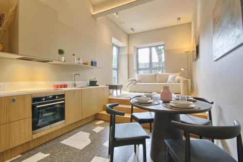 a kitchen and living room with a table and chairs at Apartamentai Astra in Druskininkai
