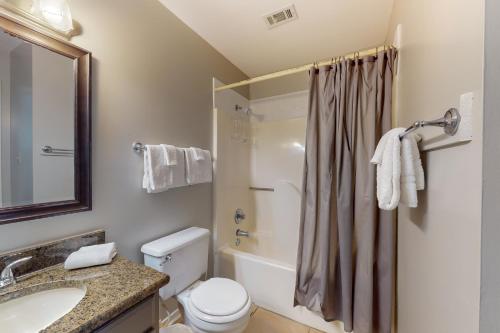 a bathroom with a toilet and a sink and a shower at Perdido Dunes #20 in Orange Beach