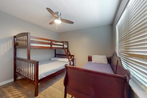 two bunk beds in a room with a ceiling fan at Perdido Dunes #20 in Orange Beach