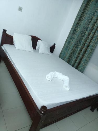 a bed with towels on it in a room at Studio Apartment.Mombasa, Kenya in Mombasa