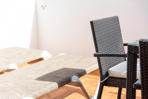 a dining room with two chairs and a table at Paloma Beach Apartments in Los Cristianos