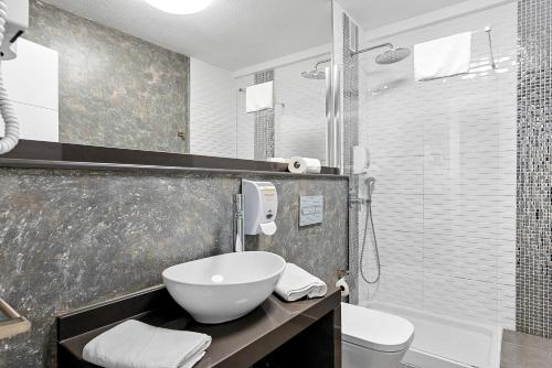 a bathroom with a sink and a toilet and a shower at Paloma Beach Apartments in Los Cristianos