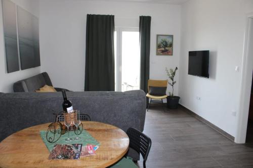 sala de estar con sofá y mesa en Apartman Maslina, en Šibenik