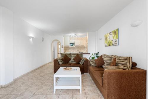 a living room with a couch and a table at Paloma Beach Apartments in Los Cristianos