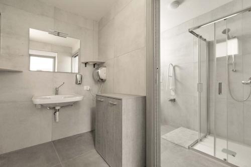 a white bathroom with a sink and a shower at Villa Queen by Perle di Puglia in Lecce