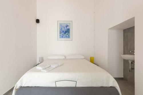 a white bedroom with a bed and a sink at Villa Queen by Perle di Puglia in Lecce