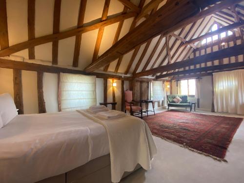 a bedroom with a white bed and a living room at The Tallow Factory in Dedham in Dedham