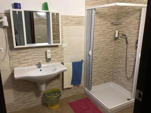 a bathroom with a sink and a shower at Albergo Europa in Marina di Mancaversa