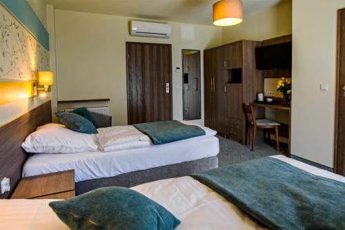 Hotel Brzozówkaにあるベッド