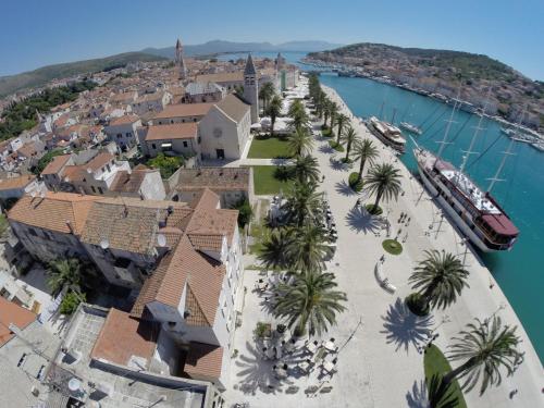 an aerial view of a resort with palm trees and a harbor at Hotel Concordia in Trogir