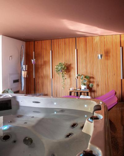 a bathroom with a large tub in a room at Villa Alma Vista in Dobrovo