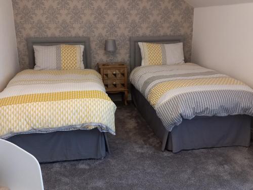 two beds sitting next to each other in a room at No. 5 in Hartlepool