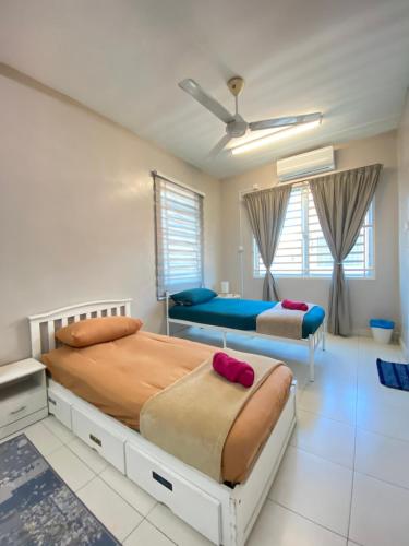 1 dormitorio con 2 camas y ventilador de techo en Homestay Aalaiya Bertam Kepala Batas - Fully Aircond, en Kepala Batas