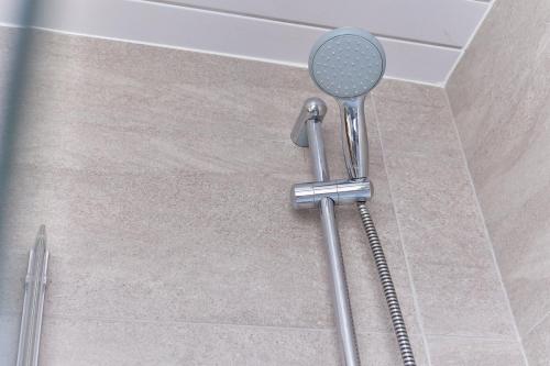 a shower in the corner of a bathroom at Properties Unique Dene Rooms - Family Room in Newcastle upon Tyne
