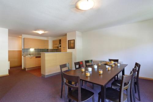 a dining room with a table and chairs at Vacancéole - Les Chalets du Verdon in La Foux