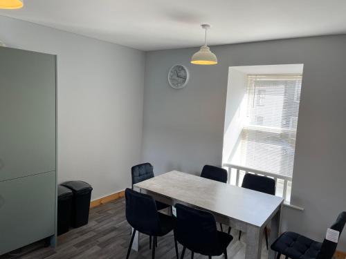 a dining room with a table and chairs at 3 Bedroom Townhouse on NC500, Wick, Highland in Wick