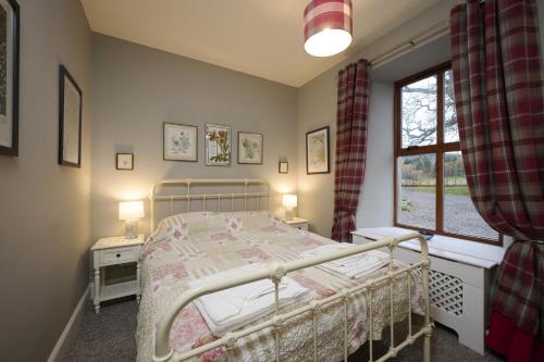 a bedroom with a bed and a window at Dunaincroy Farmhouse in Inverness