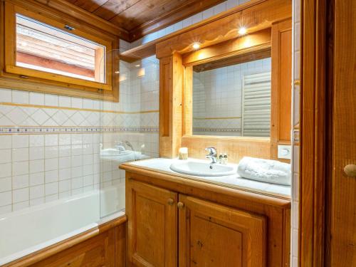 a bathroom with a sink and a mirror and a tub at Appartement Val-d'Isère, 3 pièces, 8 personnes - FR-1-694-122 in Val-d'Isère
