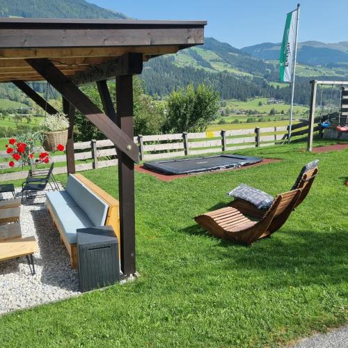 a patio with two chairs and a gazebo at Fasserhof in Bramberg am Wildkogel