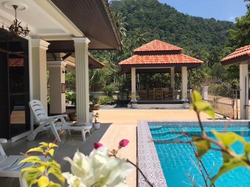 a house with a swimming pool and a gazebo at Orchid Pool -Villa 3 bedrooms in Ko Lanta