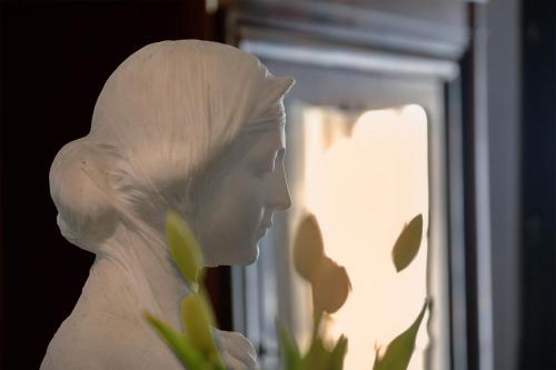 a statue of a woman looking out of a window at Relais Villa Giusso in Vico Equense