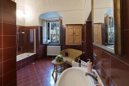 a bathroom with a tub and a sink and a mirror at Relais Villa Giusso in Vico Equense