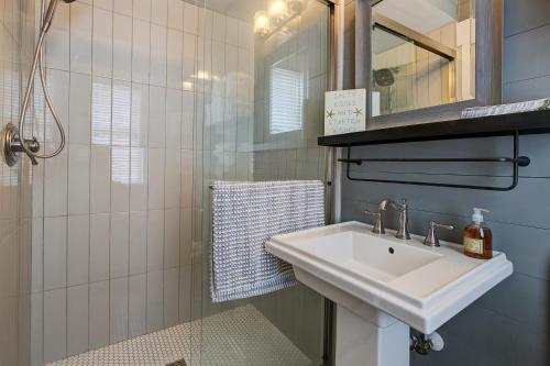 ein Badezimmer mit einem weißen Waschbecken und einer Dusche in der Unterkunft Summer Kitchen Cottage in Columbia