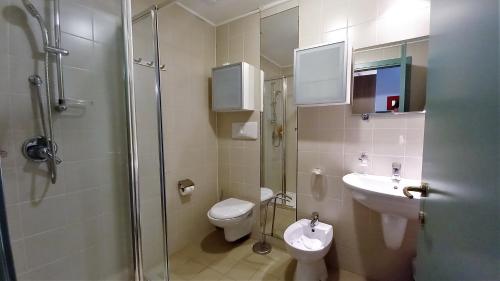 a bathroom with a shower and a toilet and a sink at villaggio olimpico in Sestriere