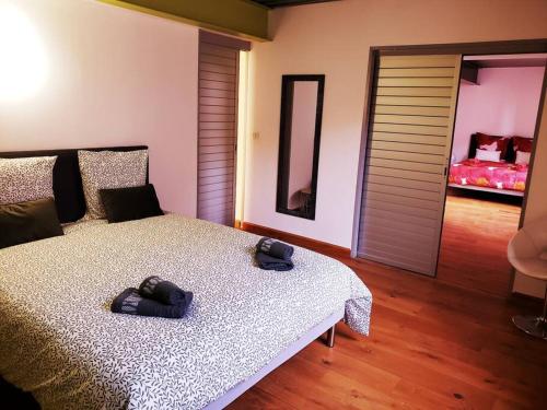 a bedroom with a bed with two controllers on it at Le loft Montilien in Montélimar