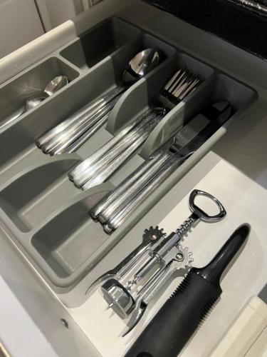 a kitchen sink with utensils in a drawer at Stunning 2 Bed/2 Bath Flat in Waterloo, London in London