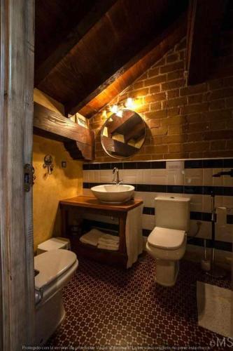 a bathroom with two toilets and a sink at CASA RURAL LA CORVA in Triollo