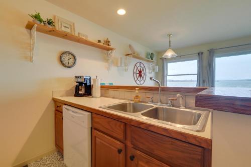 a kitchen with a sink and a counter at Beachfront Onekama Vacation Rental with Balcony! in Onekama