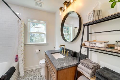 a bathroom with a sink and a mirror at Central Tulsa Cottage with Yard about 3 Mi to Downtown! in Tulsa